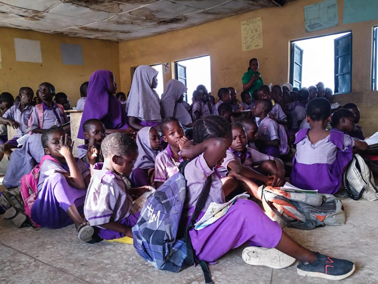 Students sitting in the ground in Nigeria school