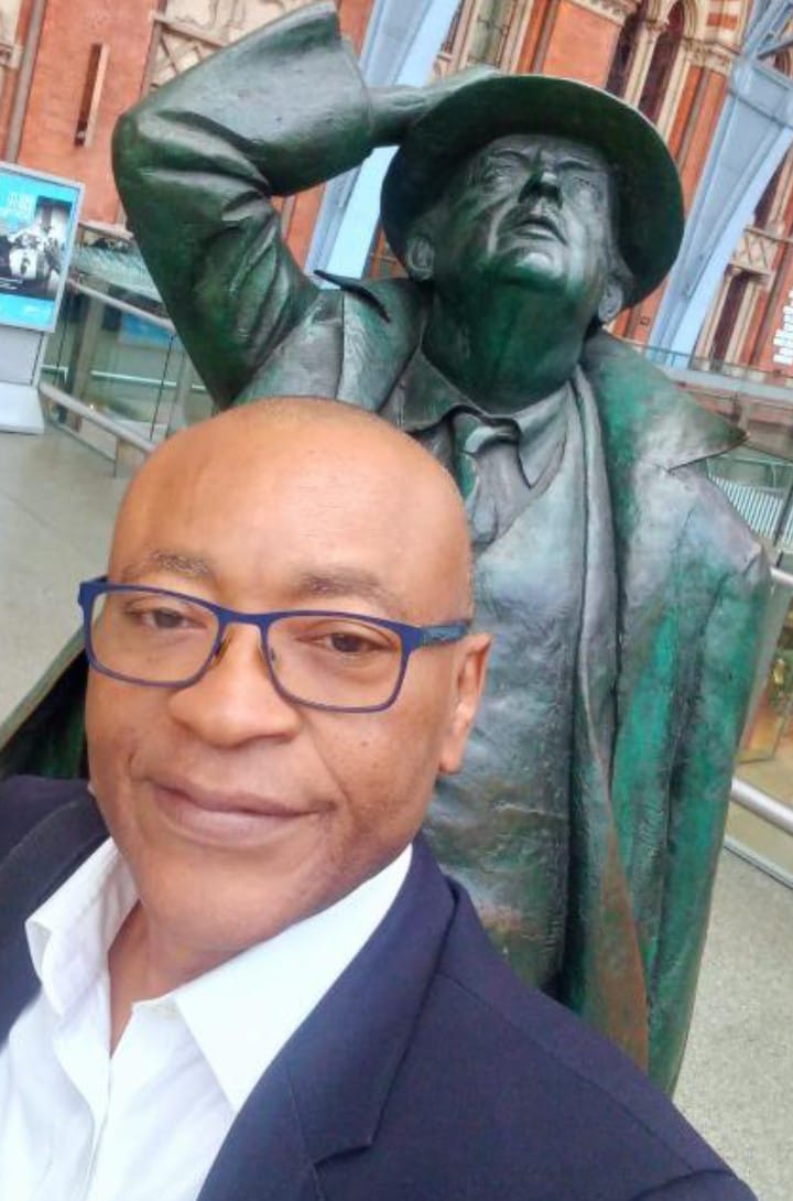 Bethlehem Rail CEO Rowland Ataguba with statue of Sir John Betjeman at St Pancras International London