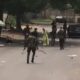 A photo shows Nigerian Army Guards Brigade officers arresting and beating a teenage girl during the protest.